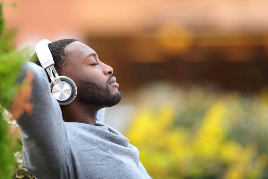 man relaxing while listening to music